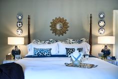 a bed with blue and white decor in a bedroom