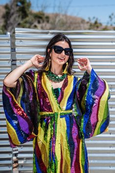 Introducing the beautifully unhinged Jennafer Grace Rainbow Road Kimono. This elegant piece boasts an iridescent sequin design with art nouveau inspiration. A wild addition to any wardrobe, this kimono can be worn as a stunning dress or layered over your favorite outfits. Don't miss out on the limited options for this must-have item. Extra long belt can be enjoyed Obi-style and features extra long fringe at ends. To preserve the luscious sequins, we recommend dry cleaning or hand washing this ga Fitted Kimono For Spring Party, Fitted Evening Kimono For Summer, Elegant Spring Party Kimono, Elegant Kimono For Party In Spring, Elegant Kimono For Spring Party, Multicolor Summer Party Kimono, Summer Party Multicolor Kimono, Spring Party Multicolor Kimono, Bohemian Spring Party Kimono