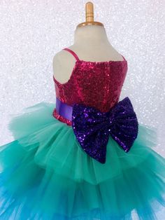 Gorgeous Trolls-inspired dress with mermaid colors with puffy ruffles makes this the perfect gown for any little girl! Handcrafted with the upmost of care and attention to detail, we make sure that each dress is perfectly one of a kind. The sparkly sequence spaghetti strap bodice is fully lined for comfort. Comes with a detachable satin ribbon belt for an adjustable fit. A detachable sequin bow comes with the dress as well for some additional shimmer. The skirt is made out of multiply colored st Recital Photoshoot, Infant Photoshoot, Photoshoot Birthday, Newborn Flower, Fall Birthday Parties, Ruffle Gown, Dress Bow, Toddler Easter, Toddler Halloween