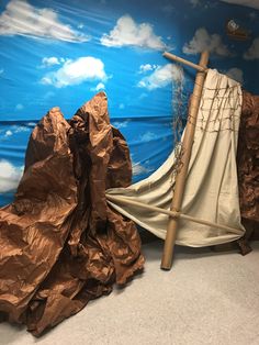 a room that has some brown paper on the floor and a wall with clouds painted on it