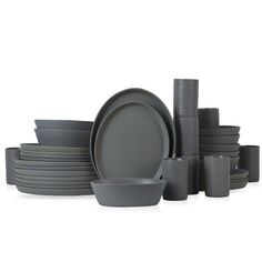 a stack of grey dishes and cups on a white background