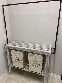 two laundry baskets sitting on top of a wooden shelf next to a metal rack with the laundry room written on it