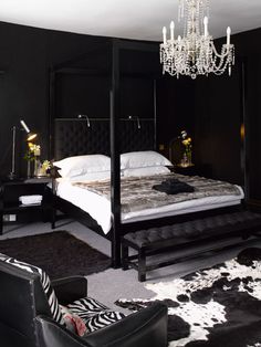 a black and white bedroom with a four poster bed