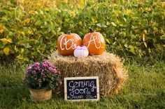 hay bale with pumpkins and chalkboard sign on it