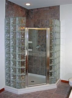 a bathroom with a walk in shower next to a sink