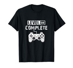 a black t - shirt with the words level 08 complete and two video game controllers