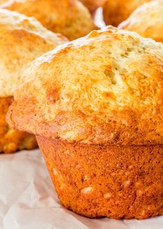 several muffins sitting on top of white paper