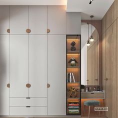 a bedroom with white cupboards and wooden floors