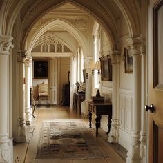 an archway leading to a living room and dining area with furniture on the other side