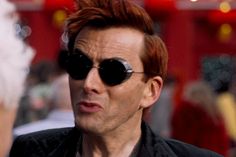 a man with red hair and black sunglasses