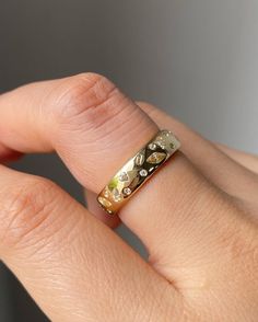 a woman's hand with a gold ring on it