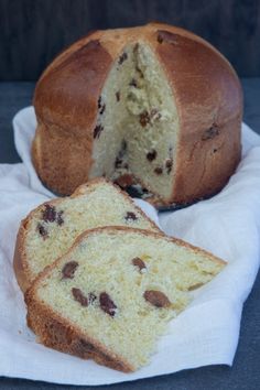 a loaf of bread sitting on top of a white napkin next to a piece of cake