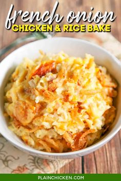 a bowl filled with chicken and rice casserole on top of a wooden table