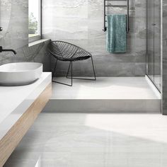 a modern bathroom with grey marble walls and floor