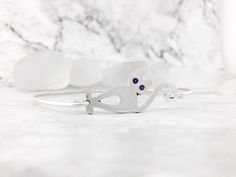 "Cute Cat Birthstone Bangle is handmade of sterling silver. The cute kitty is polished to a mirror finish. You can choose your birthstone color for the eyes from the drop-down menu along with your bracelet size. The stones are flush set into the face of the cat, they are not glued - so they will last! Everything in our shop is handmade in our studio, so this bangle will be made to order in your size. Please select your size from the drop-down menu. To measure for a bangle, use a measuring tape a Blue October, Cat Bracelet, Birthstone Colors, Personalized Ring, Jewelry Personalized, Handmade Bangles, Cute Kitty, Cat Jewelry, Aqua Marine