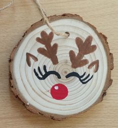 a piece of wood with a reindeer face painted on it