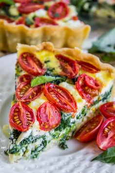 a slice of quiche with tomatoes and spinach