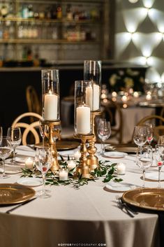 the table is set with candles and place settings