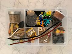 a plastic container filled with assorted items on top of a table