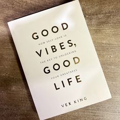 a book with the title good vibes, good life on it sitting on top of a wooden table