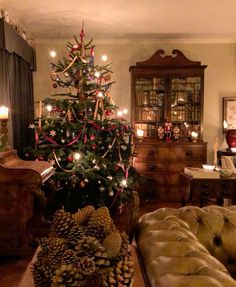 a living room with a christmas tree in the corner and other decorations on the table