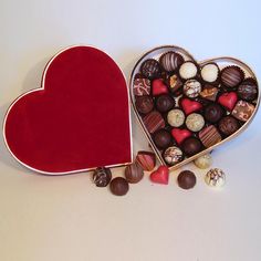 a heart shaped box filled with assorted chocolates