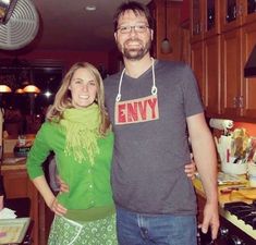 a man standing next to a woman in a kitchen