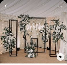 an indoor wedding setup with white flowers and greenery