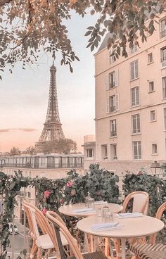 tables and chairs with the eiffel tower in the background