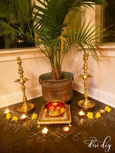 a potted plant sitting on top of a table next to candles and other decorations