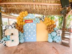 a decorated stage with balloons and decorations for a children's birthday or baby shower