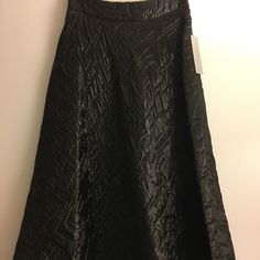 Details: * Maxi Skirt * Aline Silhouette * 34” Length * Quilted Fabric * Fully Lined * Hidden Hook & Bar And Back Zip Closure * Self: 62% Polyamide, 38% Polyester * Dry Clean Only Pleated A-line Maxi Skirt For Evening, Modern A-line Lined Skirt, Elegant Black A-line Skirt, A-line Pleated Maxi Skirt For Party, Evening Pleated A-line Skirt, Chic A-line Skirt For Party, Fitted A-line Maxi Skirt For Evening, Elegant A-line Bottoms For Evening, A-line Lined Skirt For Party