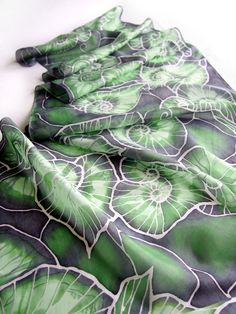 Silk scarf Begonia Leafs is hand painted with swirly leaf pattern in green. This scarves is perfect as a St. Patrick day celebration and as a unique gift for greenery lover or biologist. Size: 61 by 17 inches (155 na 43 centimeters) Silk: pure Habotai Light, delicate and lightweight. The Begonia Leaf scarf is made to order in 3 days! It is a big, wrap scarf with a design of swirling begonia leafs creating a 3D effect. The scarf is a bit transparent (made of pure silk Habotai Light) and it is ver Artistic Green Silk Scarf With Floral Print, Green Floral Print Scarves As Gift, Green Floral Print Scarf For Gift, Artistic Green Silk Scarf As A Gift, Hand Painted Green Silk Scarf, Artistic Hand Painted Green Silk Scarf, Elegant Handmade Green Silk Scarf, Begonia Leaf, Plant Mom Aesthetic