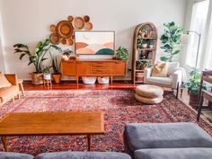 a living room filled with furniture and plants