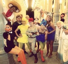 a group of people in costumes posing for a photo