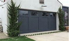 a house with two large garage doors on the side