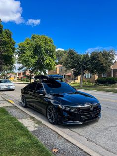 a black car is parked on the side of the road