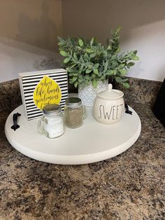 there is a tray with spices on it and a potted plant next to it