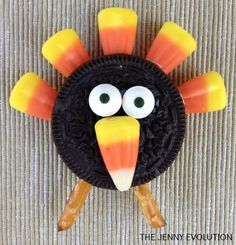 a cookie decorated like a turkey with googly eyes