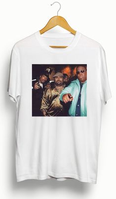 The Big Pac Pun T-Shirt is the perfect addition to any music lover's wardrobe. Featuring legendary rappers Notorious BIG, Tupac, and Big Pun, this shirt showcases the iconic talent and impact of these artists. Made with high-quality material, it offers both style and comfort. A must-have for fans and collectors alike. Features • 5.3 oz., 100% preshrunk cotton • Double-needle sleeve and bottom hems •Taped neck and shoulders•Classic midweight fabric•Classic fit tubular body •7/8" collar•Classic fi White Hip Hop T-shirt For Concert, White Pop Culture Tops For Streetwear, Pop Culture Shirt With Sublimation Print For Streetwear, Hip Hop White Shirt For Streetwear, White Hip Hop Shirt For Streetwear, 90s Style White Streetwear Shirt, Urban Style White T-shirt For Concert, Urban White T-shirt For Concerts, White Urban T-shirt For Concert