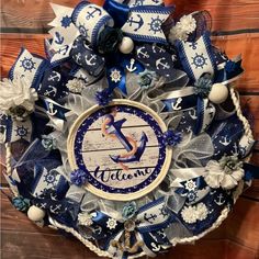 a blue and white wreath with an anchor on it