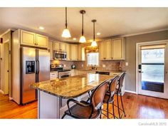 a kitchen with marble counter tops and stainless steel appliances