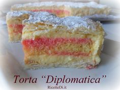 two pieces of cake with powdered sugar on top and the words torta diplomatica written below