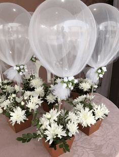 some white flowers and balloons are on a table with the words queriddata