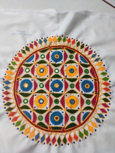 an embroidered cloth with colorful designs on it