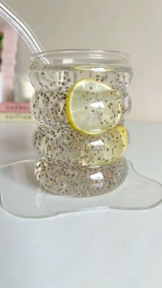 a glass jar filled with lemon slices and seeds