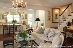 a living room filled with furniture and a chandelier