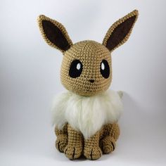 a crocheted stuffed animal sitting on top of a white surface