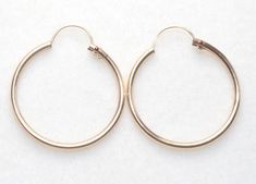 Gorgeous PETITE pair of  vintage 14k gold filled HOOP earrings.  THESE ARE OLD STOCK GOLD FILLED HOOPS  They are 20  mm round  in diameter hoops. The inside of Hoops are 17mm. These are Good Size  Hoops.   This piece is original. They made by A & Z company around 1950's.  They look and feel like real gold at the fraction of cost. Just try one piece and you will be amazed. These are roll gold and will be your best friends for  lifetime. Made by A & Z company operated from 1940- 1970's and guarant Classic 14k Stamped Hoop Earrings, Hinged Round 14k Gold Jewelry, Hinged 14k Gold Round Jewelry, Classic 14k Gold Filled Hoop Earrings For Anniversary, Round Hinged 14k Gold Jewelry, Classic Round Hinged Earrings, Classic Round Earrings, Classic Hinged Hoop Earrings, Classic Gold Hinged Earrings