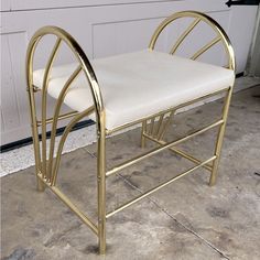 a white chair sitting on top of a tile floor next to a garage door with a metal frame